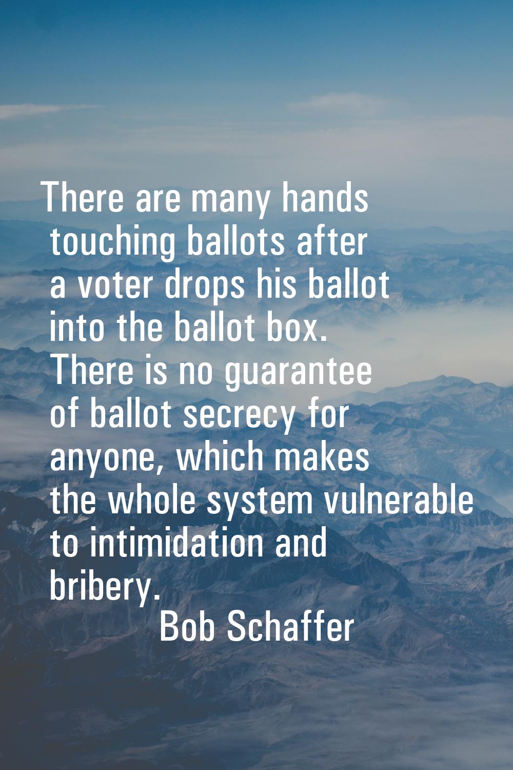 There are many hands touching ballots after a voter drops his ballot into the ballot box. There is 