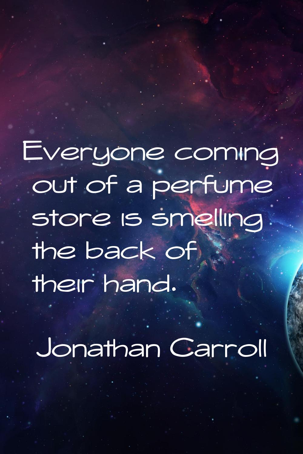 Everyone coming out of a perfume store is smelling the back of their hand.